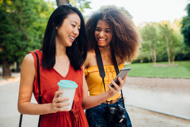 istock Two friends walking in park 1161209860