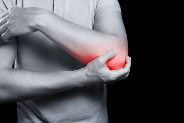 istock Pain in elbow on black background 1161210297
