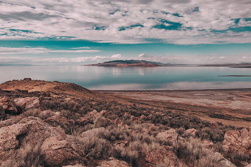 Views of Great Salt Lake on Antelope Island State Park Utah, USA. Desert landscape, water reflections, dramatic clouds.