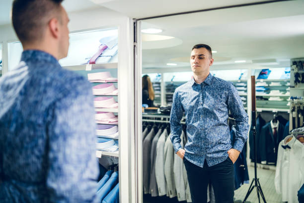 istock Man trying shirt in a store 1161216825