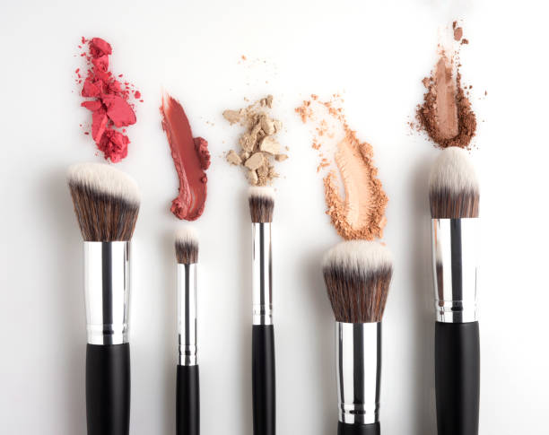 Beauty brushes. Creative concept beauty fashion photo of cosmetic product make up brushes kit with smashed lipstick eyeshadow on white background. stage makeup stock pictures, royalty-free photos & images