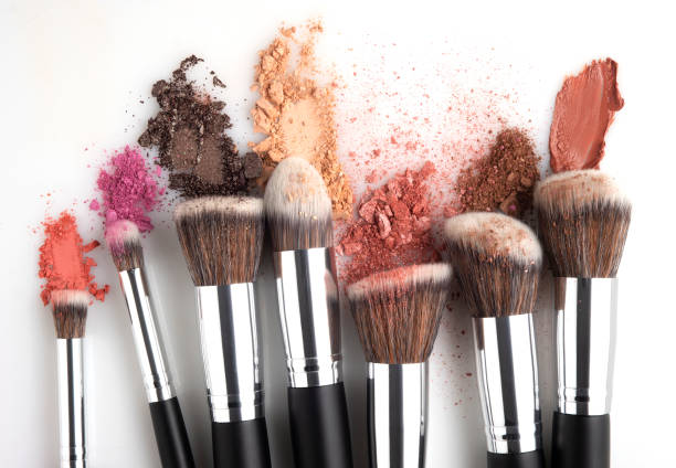 Beauty brushes. Creative concept beauty fashion photo of cosmetic product make up brushes kit with smashed lipstick eyeshadow on white background. stage make up photos stock pictures, royalty-free photos & images