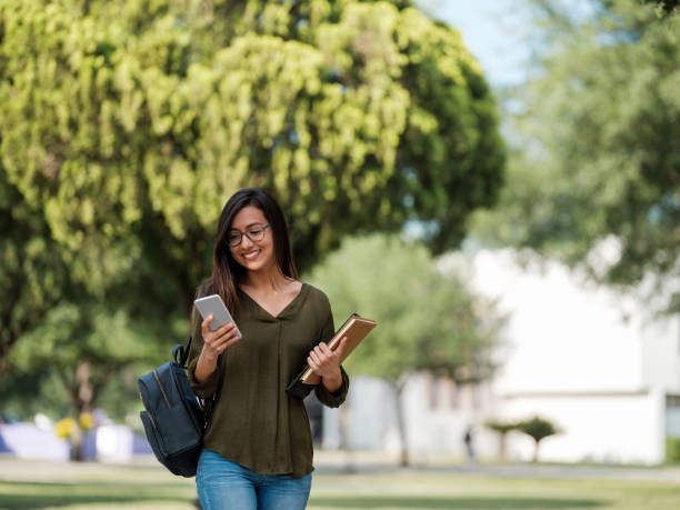 istock Millennial college student checking her smartphone 1161222686