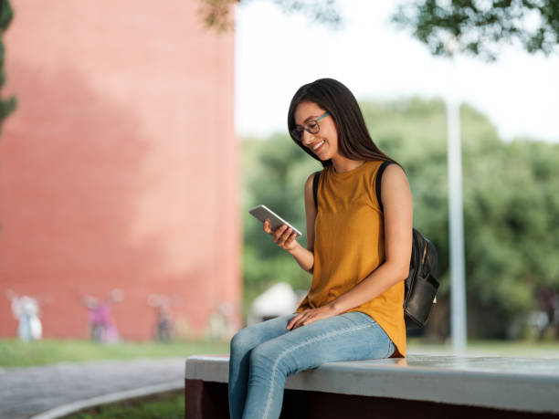 istock College girl waiting for next class while looking at her phone 1161222715