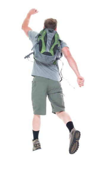 istock Friendly male hiker is jumping with excitement, rear view 1161226530
