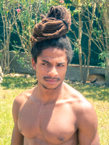 istock Black man with afro hair and dreadlocks gathered over his head. 1161226772