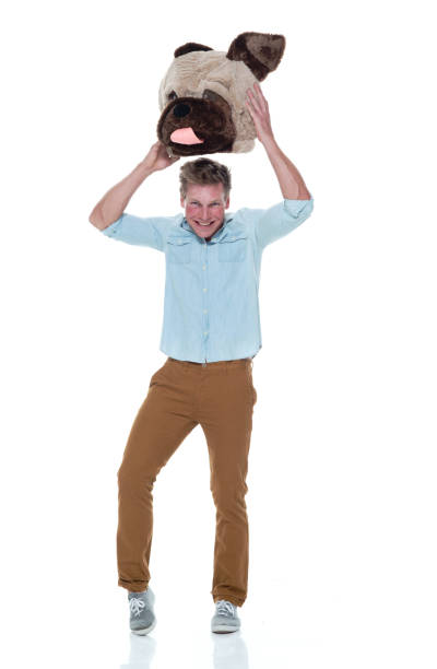 istock Casual well dressed man holding a dog head costume 1161226782