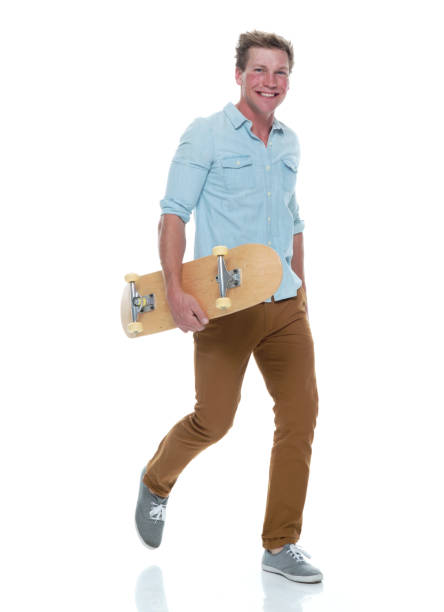 istock Casual well dressed man walking with a skateboard 1161226815