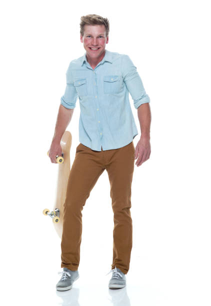istock Casual well dressed man holding a skateboard 1161226840