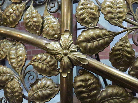 a decoration of yellow brass leaves in an old church