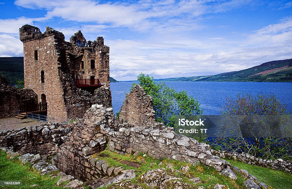 Ruins of Urquhart Castle on the hill next to blue waters Urquhart Castle at Loch Ness Scotland Loch Ness Stock Photo