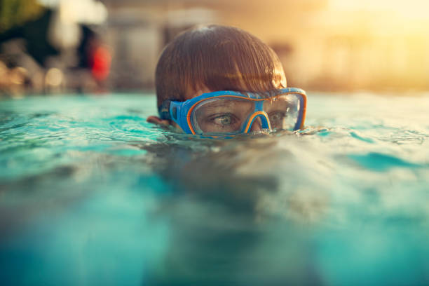 istock Little boy enjoying swimming in swimming pool 1161235547