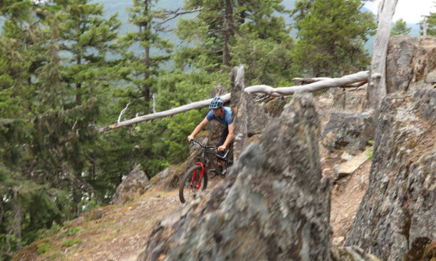 istock Mountain biker rides down steep rock slab 1161241576