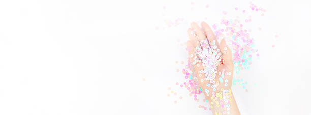 istock Pearl pastel confetti sparkles with woman hand 1161241646