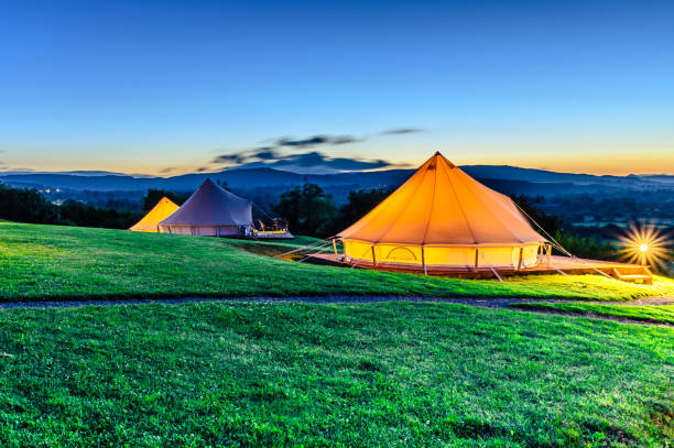 Glamping Picture of tents in camp during the sunset yurt photos stock pictures, royalty-free photos & images
