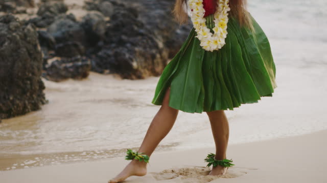 Woman performing Hawaiian hula on the beach