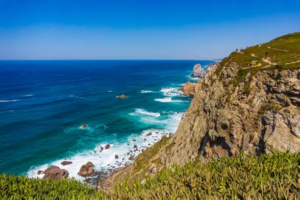 Photo of Cliffs and rocks on the Atlantic ocean coast - Praia da Ursa beach