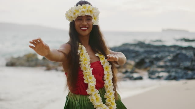 Woman performing Hawaiian hula on the beach
