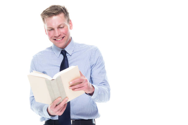 istock Handsome attractive man in business attire on white background - holding book 1161244853
