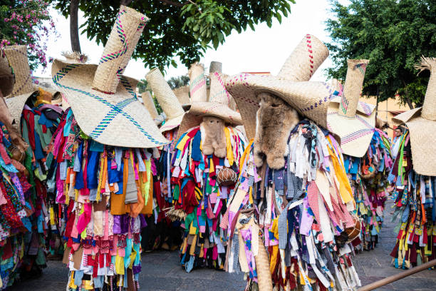 Oaxaca, Oaxaca, Mexico- July 6, 2019: Men dressed as tiliches, traditional costume from Putla, Oaxaca, during the Convite, a party made for invite to a big traditional party called Guelaguetza in Oaxaca, Mexico