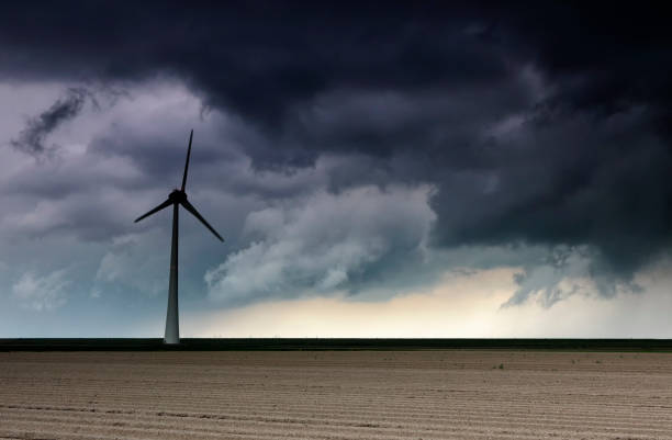 dark storm cloud over windturbine and field, Netherlands