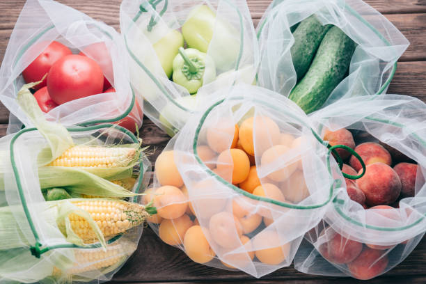 Fruits and vegetables in reusable eco mesh bags. stock photo