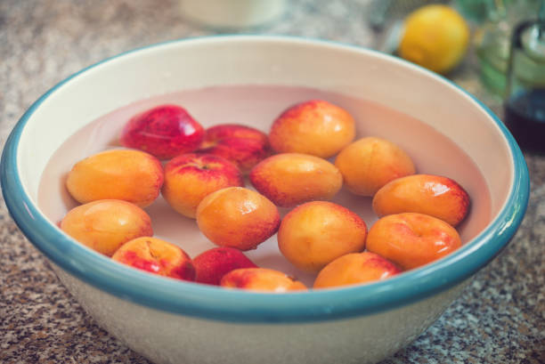 Cleaning and washing fresh apricots for making homemade jam