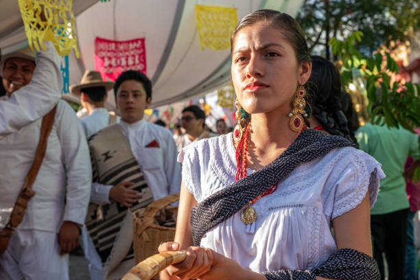 Oaxaca, Oaxaca, Mexico- July 6, 2019: Young woman dressed with traditional clothes during the Convite, a party made for invite to a big traditional party called Guelaguetza in Oaxaca, Mexico