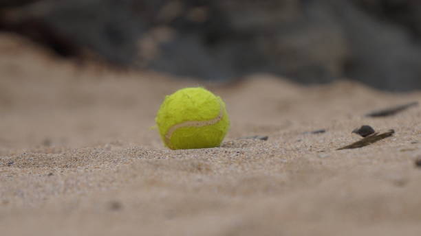 istock Tennis ball abandoned on a beach at Harlyn Bay, Cornwall. 1161252994