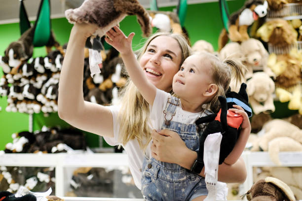 Mother and daughter shopping for stuffed animals Mother and daughter shopping for stuffed animals toy store stock pictures, royalty-free photos & images