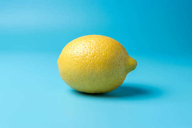 istock Fresh lemon on blue background. Minimal food concept. 1161258142