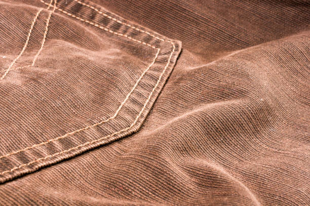 istock clothing items stonewashed cotton fabric texture with seams, clasps, buttons and rivets, macro 1161258986
