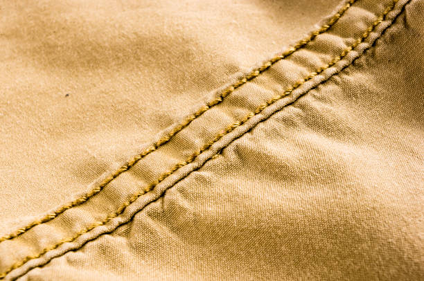 istock clothing items stonewashed cotton fabric texture with seams, clasps, buttons and rivets, macro 1161259264