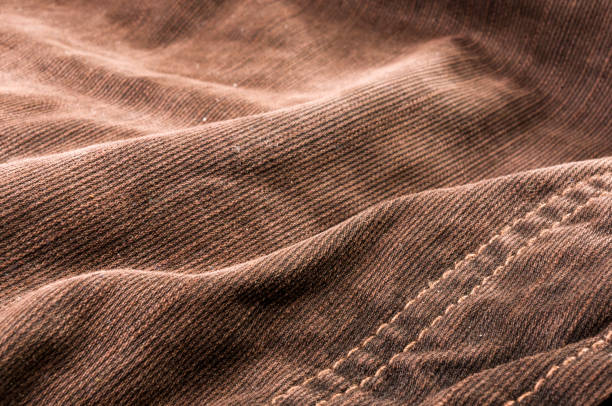 istock clothing items stonewashed cotton fabric texture with seams, clasps, buttons and rivets, macro 1161259892