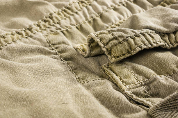 istock clothing items stonewashed cotton fabric texture with seams, clasps, buttons and rivets, macro 1161259962