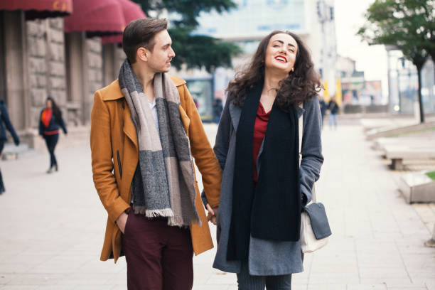 istock Young couple having a pleasant walk in the city 1161260149