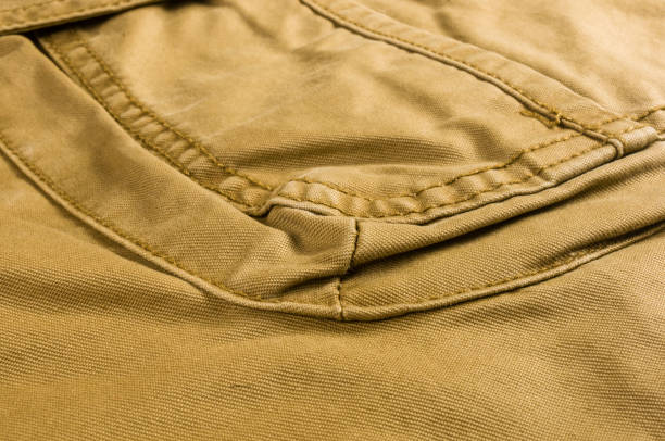 istock clothing items stonewashed cotton fabric texture with seams, clasps, buttons and rivets, macro 1161260180