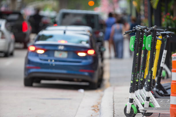 Lime electric rental scooters on the streets of Fort Lauderdale FL Fort Lauderdale, FL, USA - July 6, 2019: Lime electric rental scooters on the streets of Fort Lauderdale FL lime scooter stock pictures, royalty-free photos & images