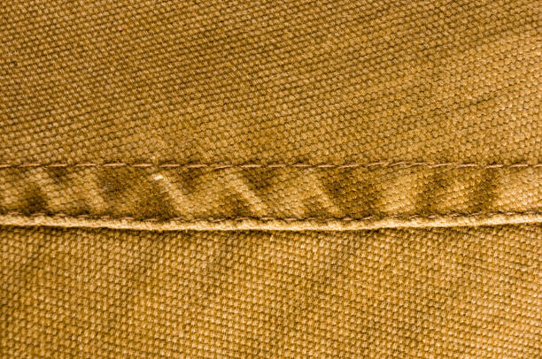 istock clothing items stonewashed cotton fabric texture with seams, clasps, buttons and rivets, macro 1161260214