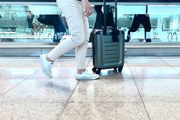 istock Man or woman walking with a suitcase 1161260378