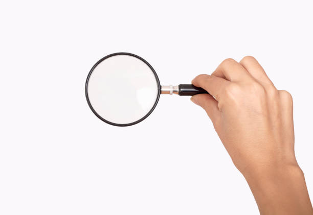 magnifying glass in hand isolated on white background
