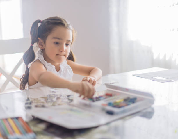istock little girl drawing at home 1161266352