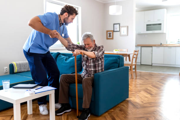 istock Caregiver Helping Senior Man 1161266930