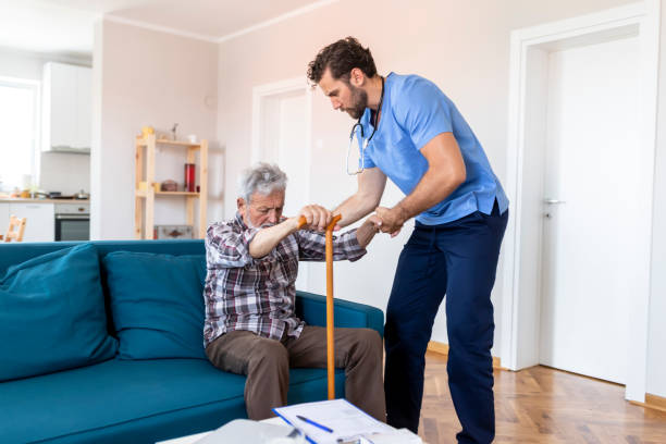 istock Caregiver Helping Senior Man 1161266931