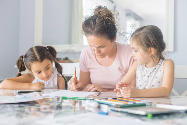 istock teacher helping girls with homework 1161267976