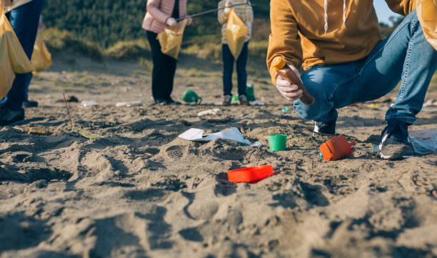 istock Young man cleaning the beach 1161268137