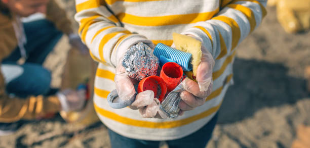 boy hands with garbage from the beach - wasting time imagens e fotografias de stock