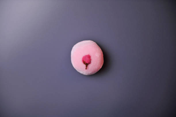 Sakuramochi - Japanese spring with cherry blossom sweets Steamed sweet where bean paste is wrapped in dough made from flour. There are ones with pink dough and ones that have salted cherry blossom on top. mochi cherry blossom cake stock pictures, royalty-free photos & images