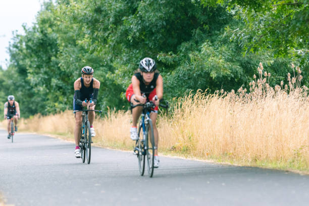istock Senior triathletes cycling on a paved rural trail 1161275914
