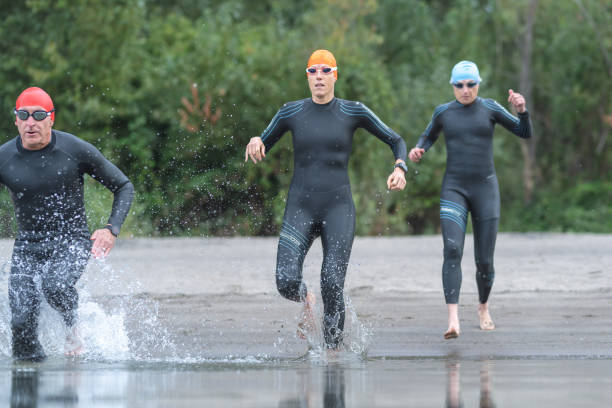 istock Triathletes run into the water 1161275987